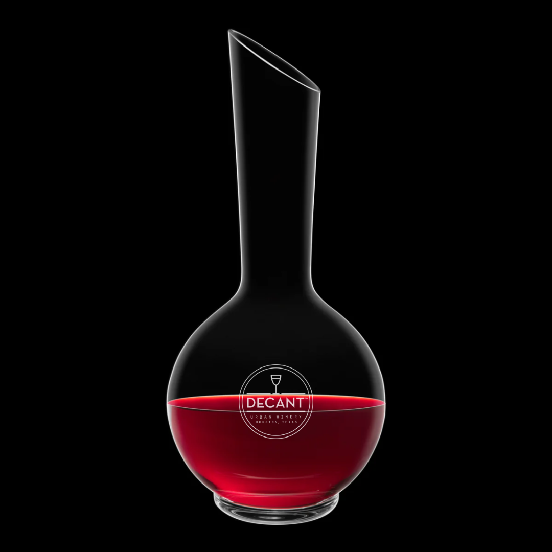 Wine decanter with red liquid on a black background
